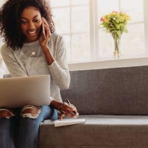woman on phone and laptop