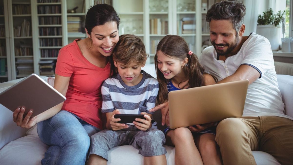 Family at home on their phone and laptop