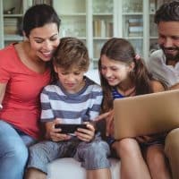 Family at home on their phone and laptop
